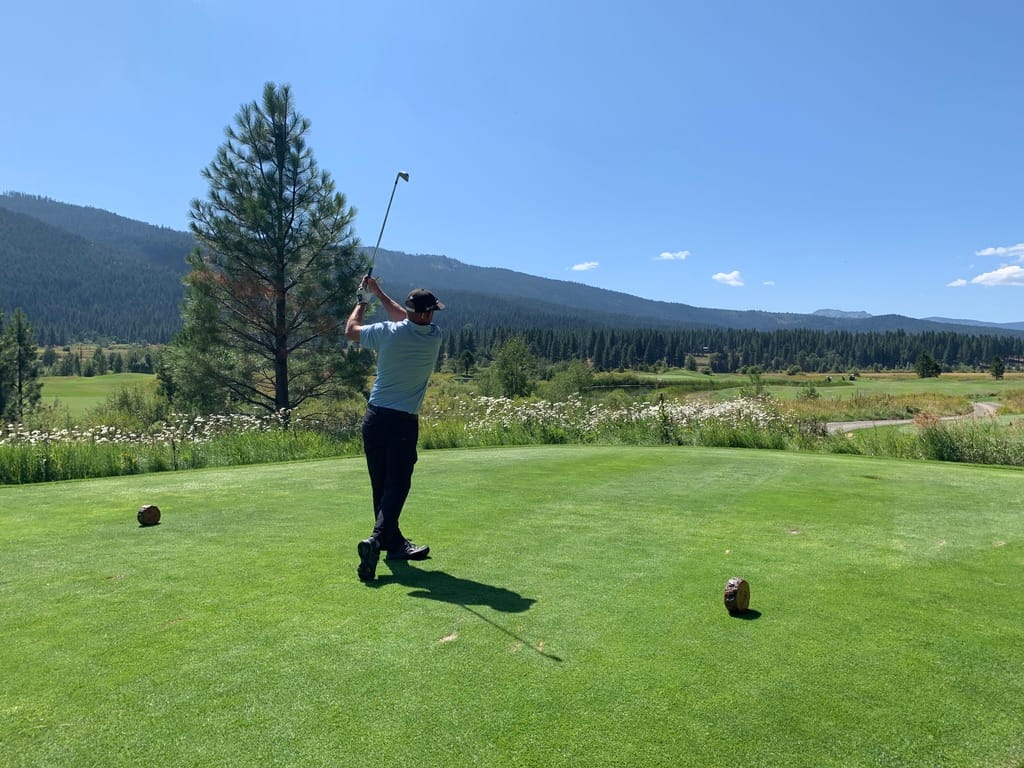 Golfer swinging on a scenic course, symbolizing progress and mastery