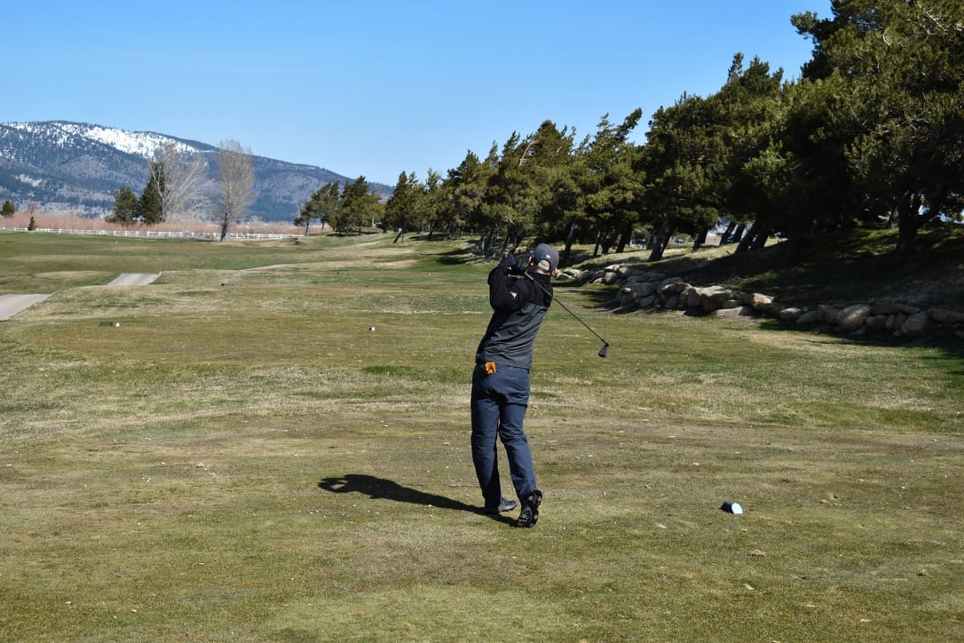 Golfer hitting a trusted club off the tee, building confidence early in the round