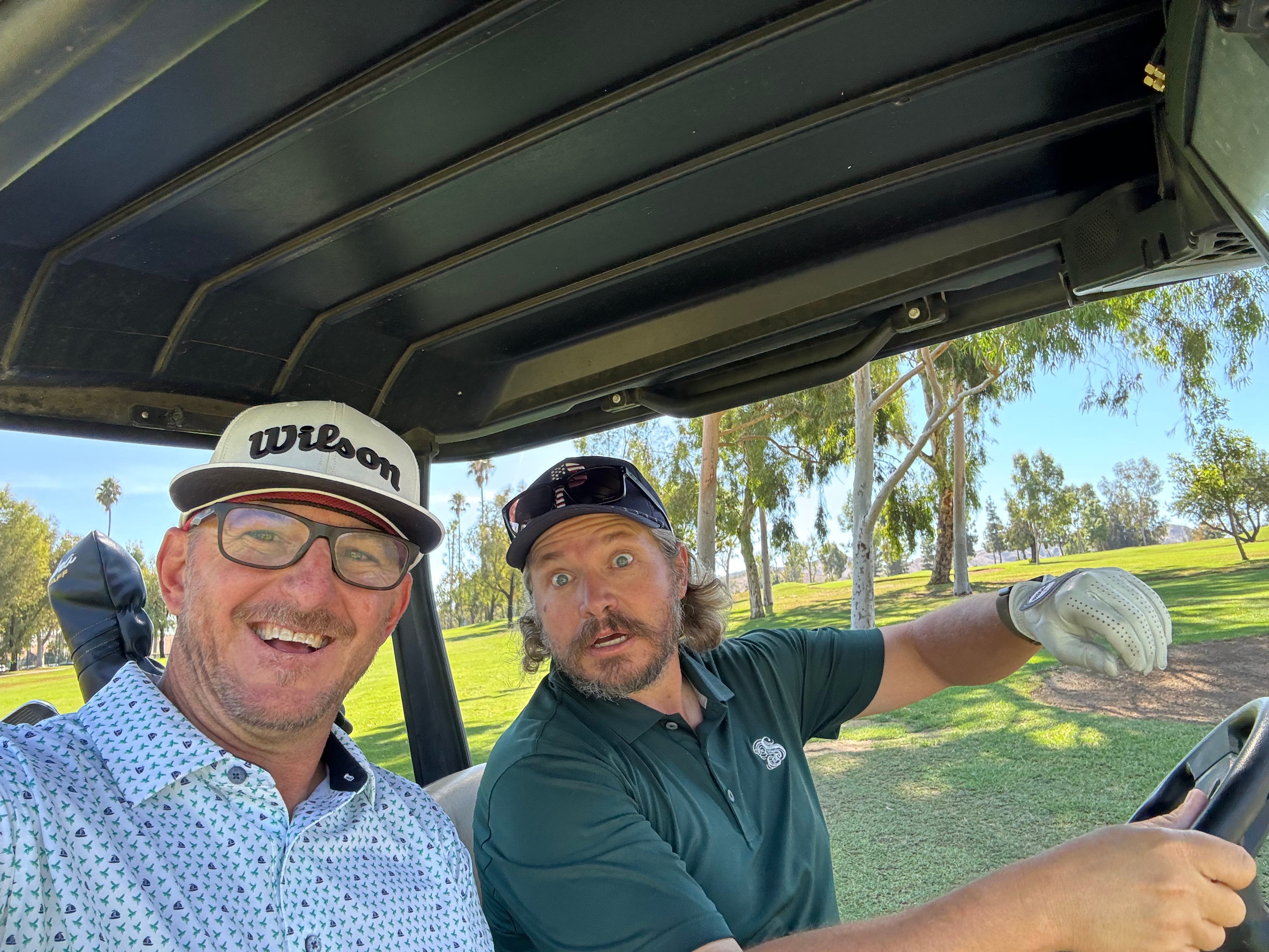 Friends in golf cart enjoying golf community on golf course